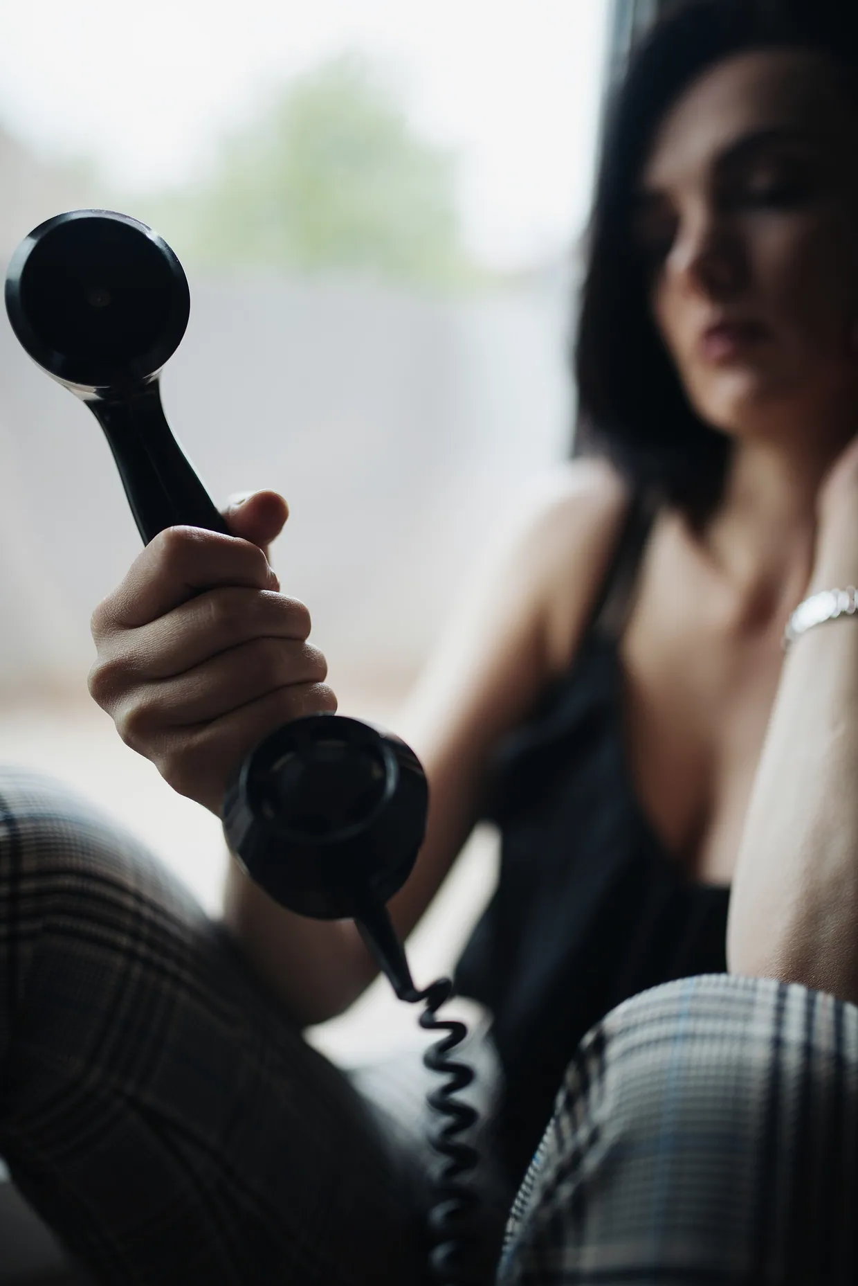 Close-up of a telephone handset in a womans hand